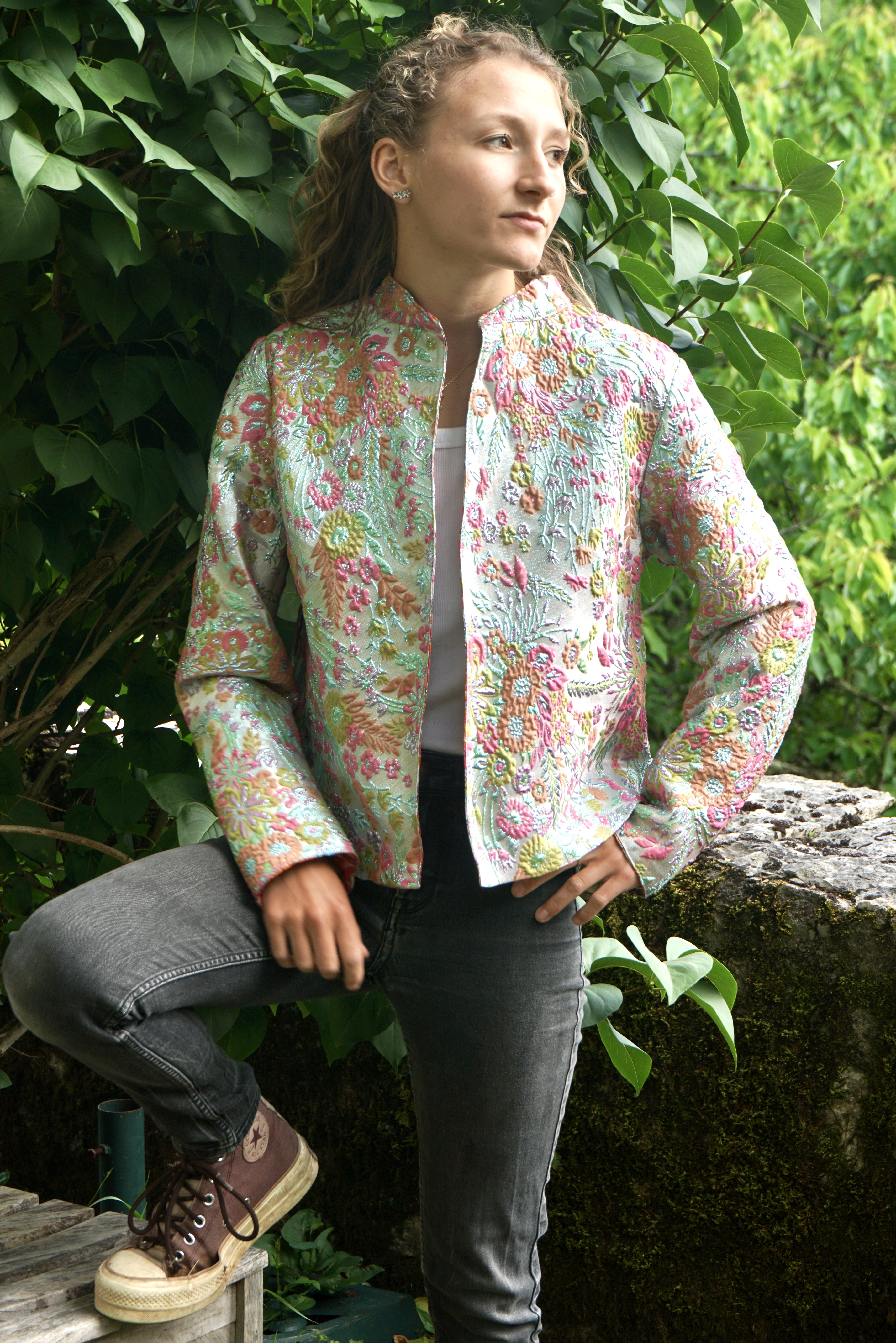 Model outside in silvery embroidered jacket