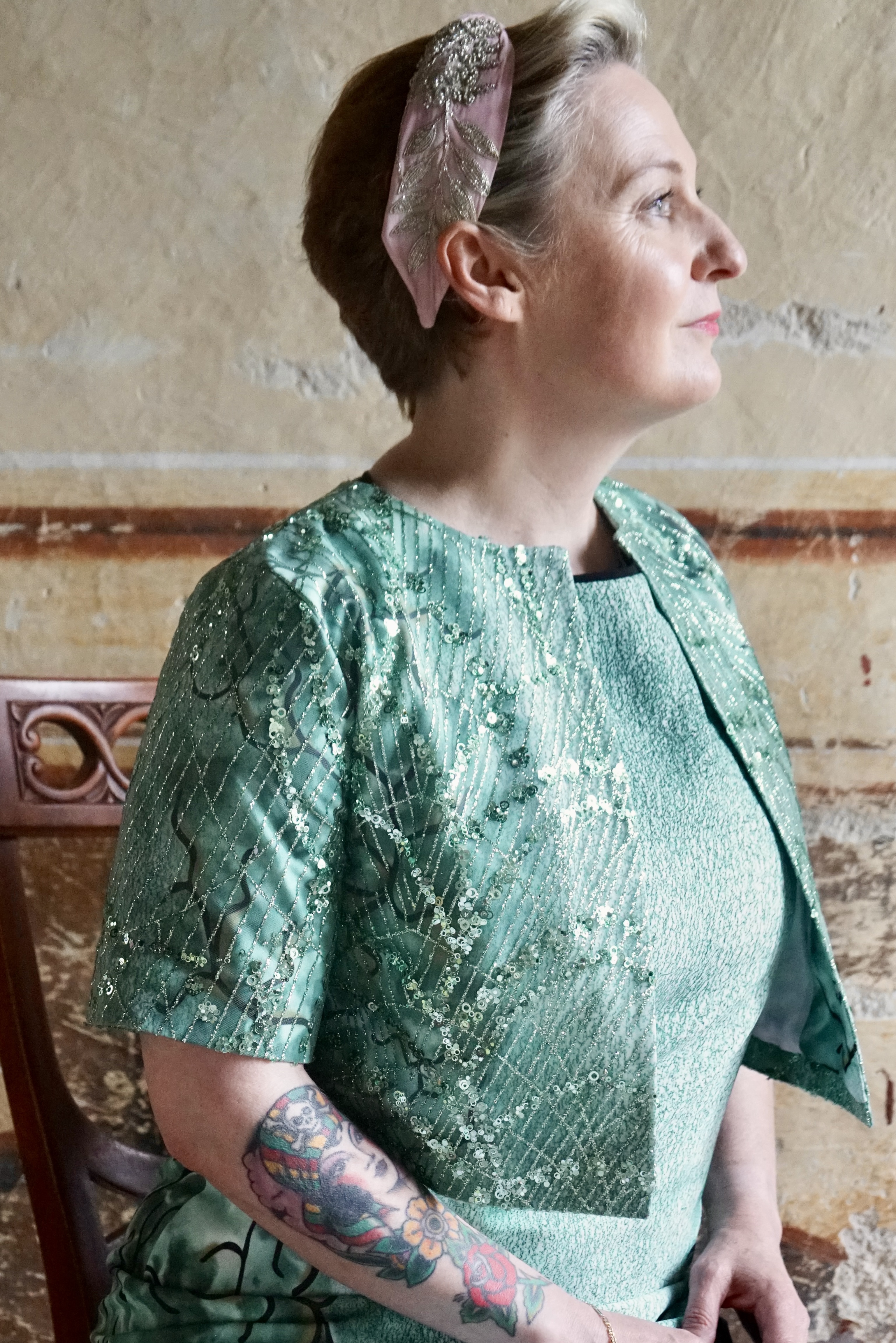 Close up of pearly jacket of the green dress