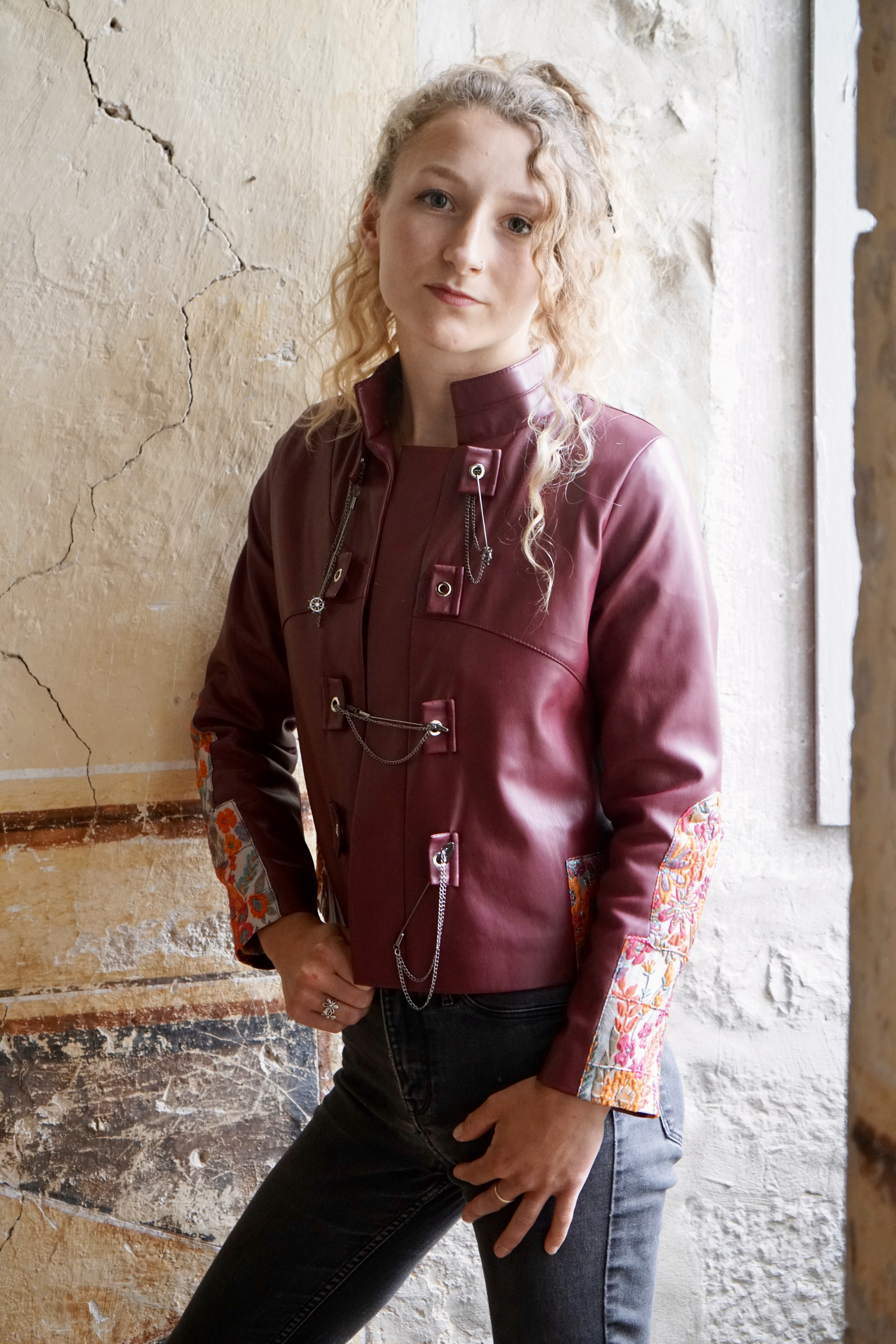 Close up of short leather jacket with unusual trim
