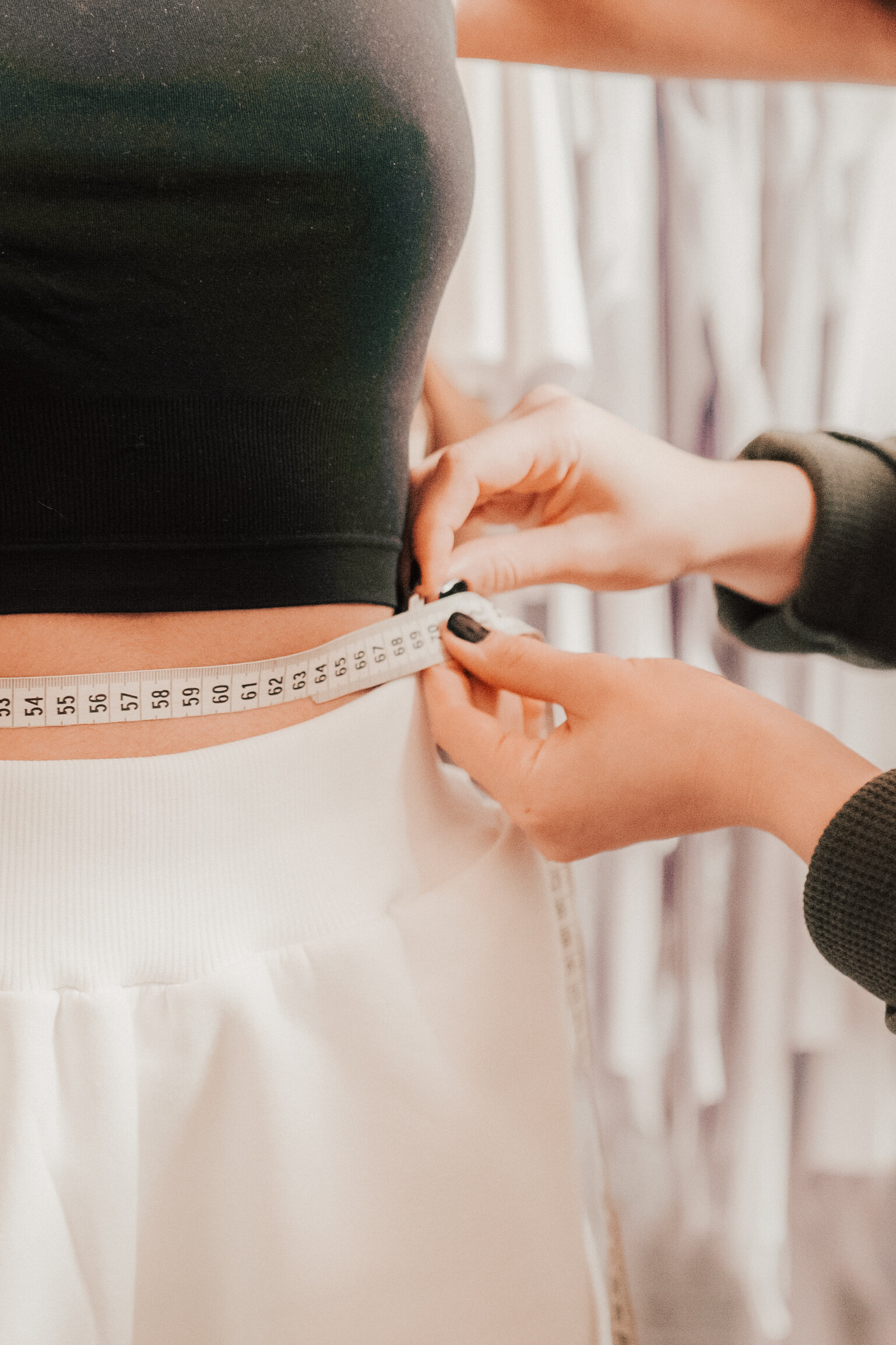 Model being measured with tape measure
