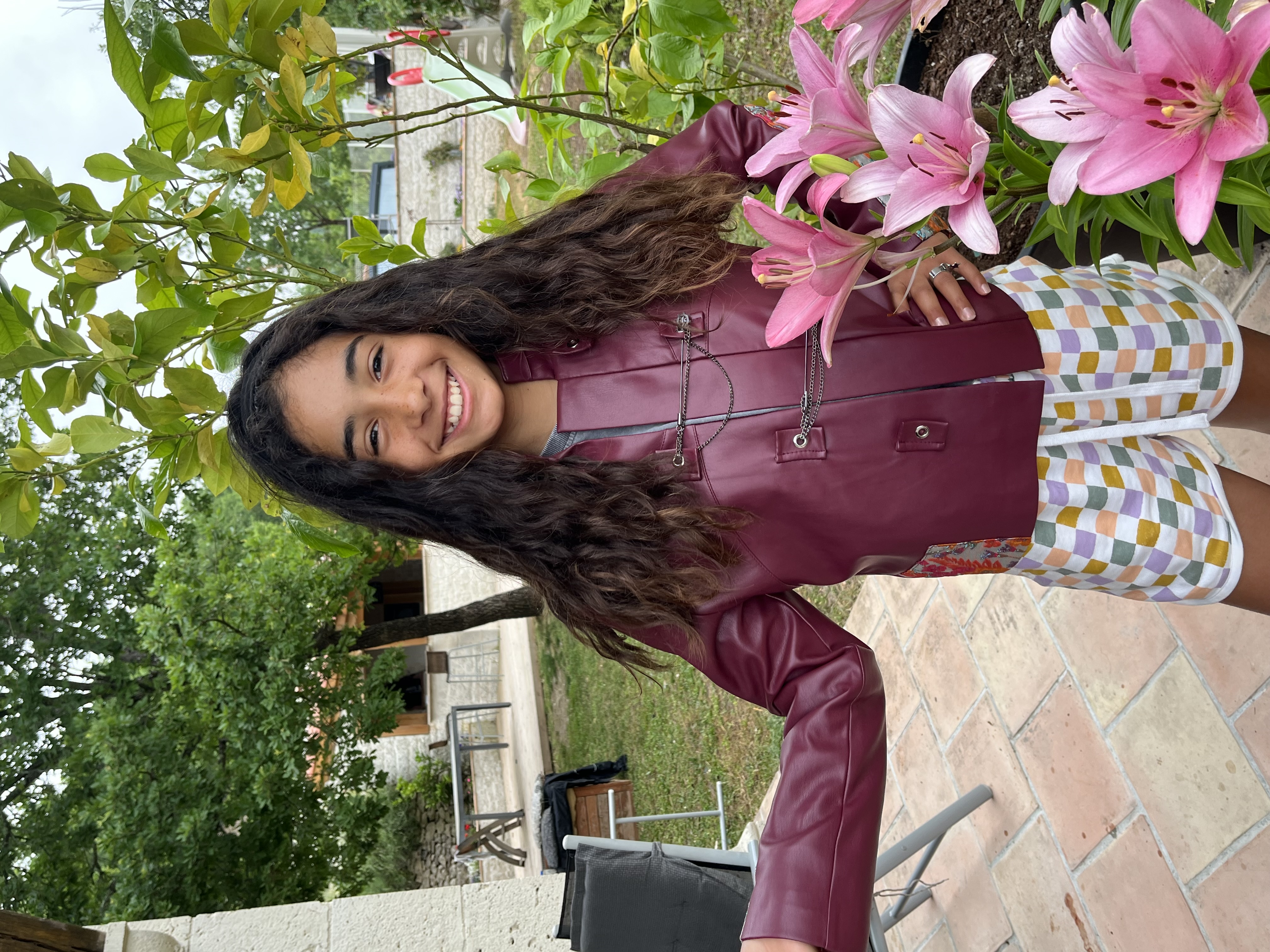 A young girl customer wearing a red leather jacket with patched sleeves
